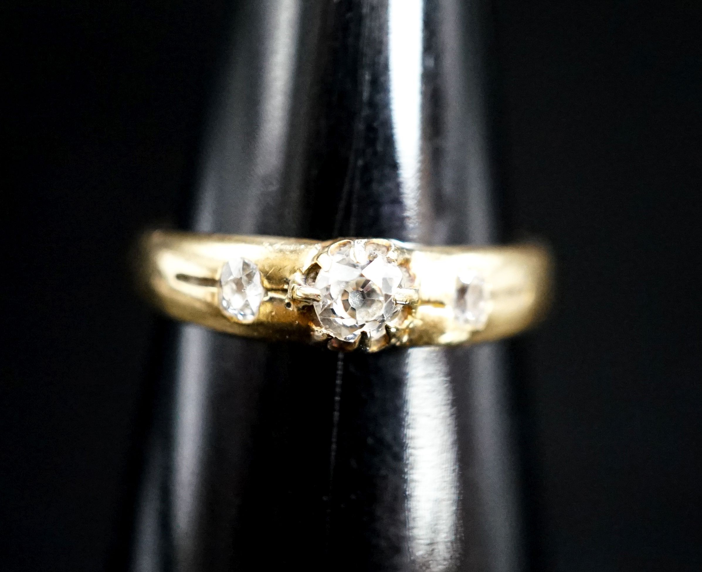 An 18ct and three stone claw and gypsy set diamond ring, size O/P, gross weight 4.2 grams.